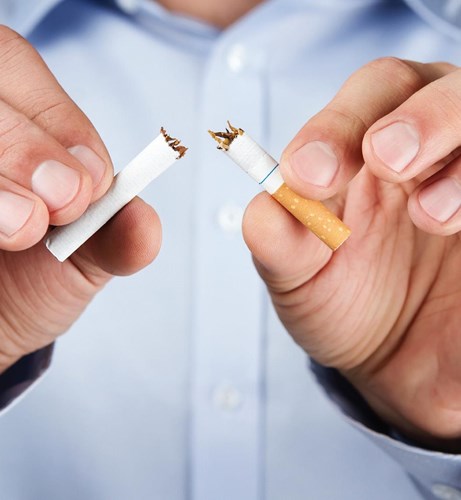 A photo of a man snapping a cigarette