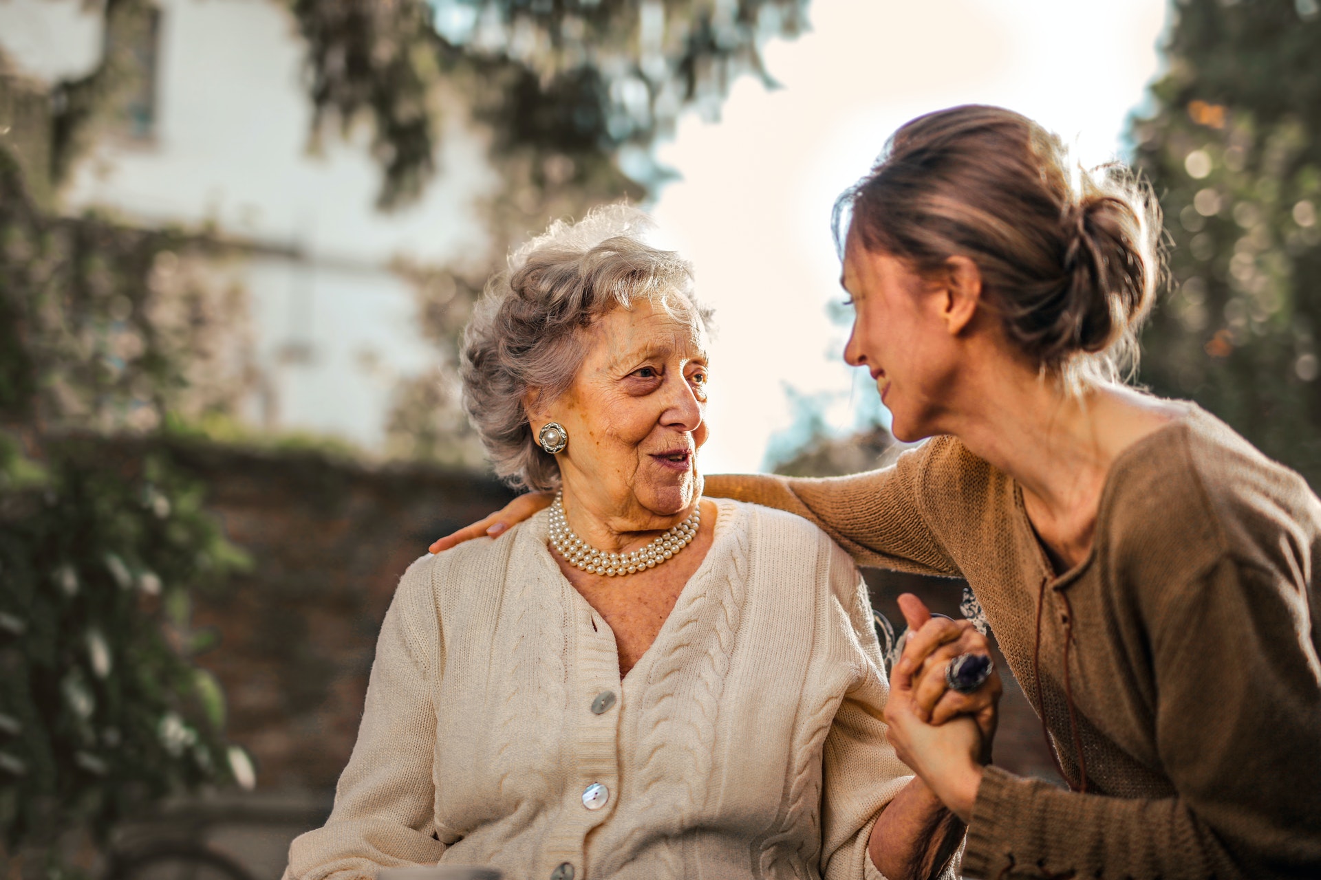 A smiling older woman with her daughter
