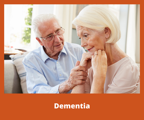 A concerned older man sitting next to an older woman