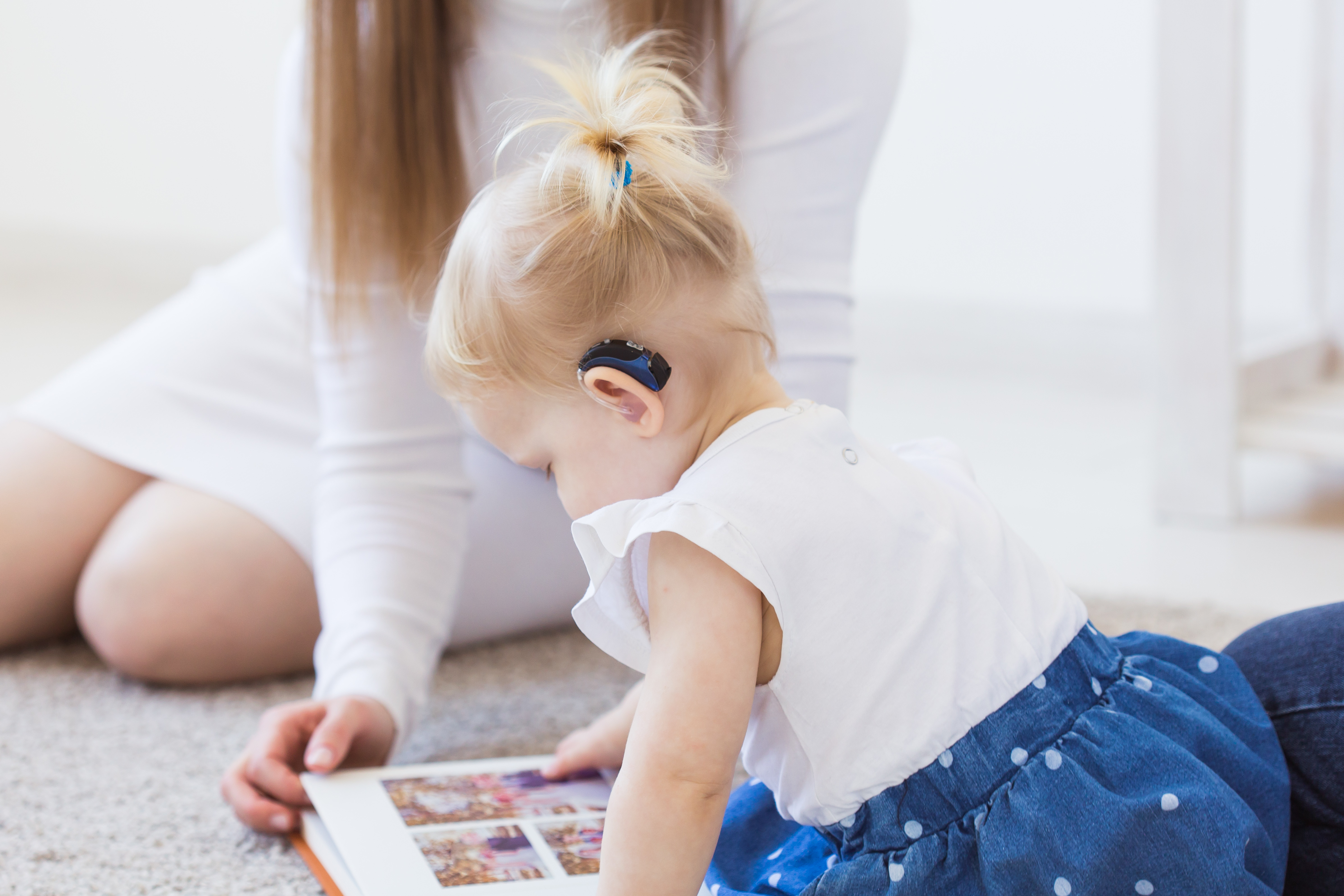A young girl wearing a hearing aid