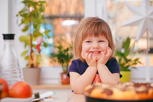 A photo of a smiling toddler