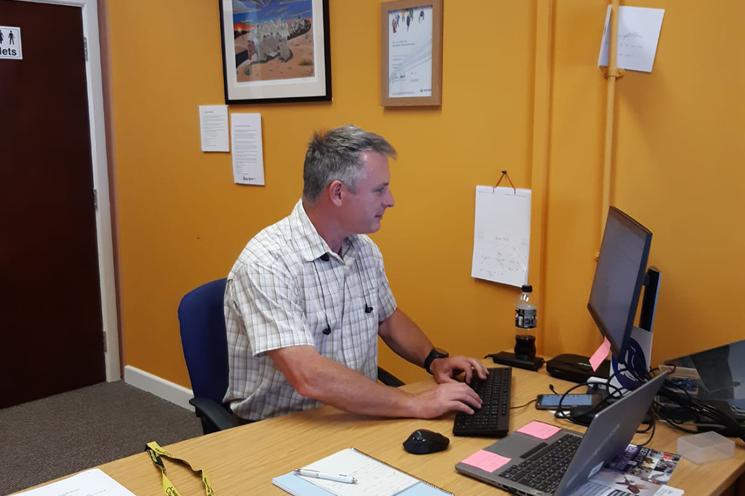 A volunteer working on a computer inside the Herefordshire Veteran Support Centre